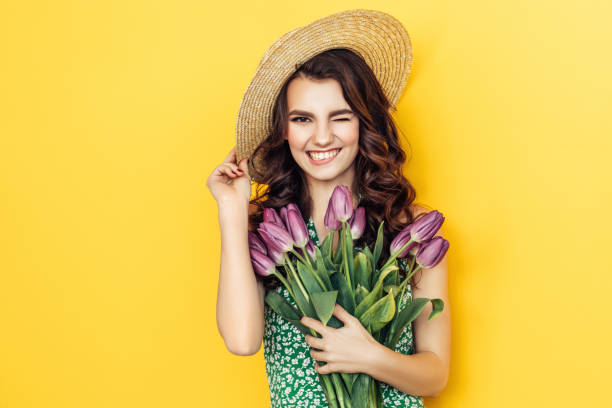 istock Lovely woman with purple tulips bunch 937537032
