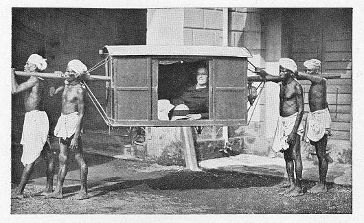 European man aboard a palanquin (sedan-chair/litter) in Delhi, India during the british era. Vintage halftone circa late 19th century.