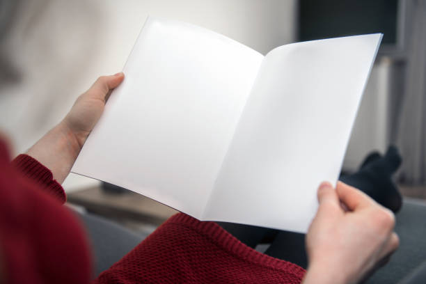 looking at a blank brochure with copy space - newspaper reading blank women imagens e fotografias de stock