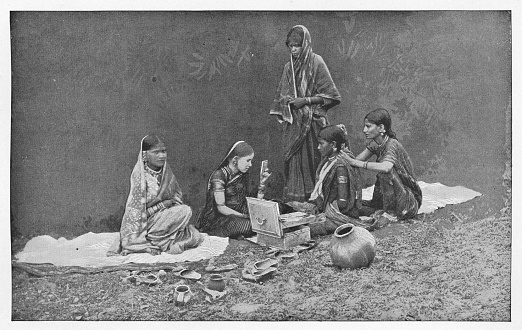 Ladies doing their hair and makeup at an outdoor boudoir in Agra, India during the british era. Vintage halftone circa late 19th century.