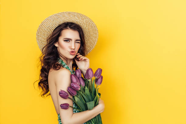 istock Lovely woman with purple tulips bunch 937543548
