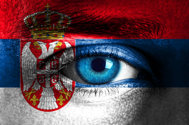 istock Human face painted with flag of Serbia 937547730