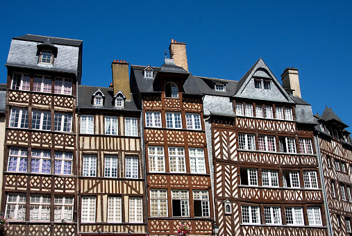 The half-timbered buildings of historic Rennes, Brittany, Northern France, against clear blue sky