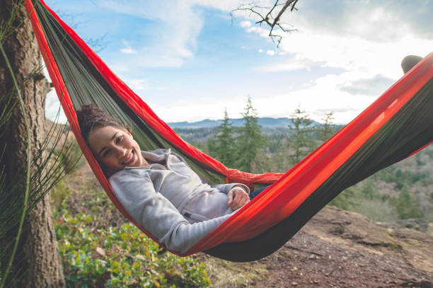 istock A young woman relaxes in a hammock in the forest 937550564
