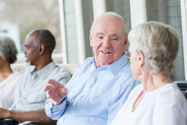 istock Senior couple talks on front porch together 937553110