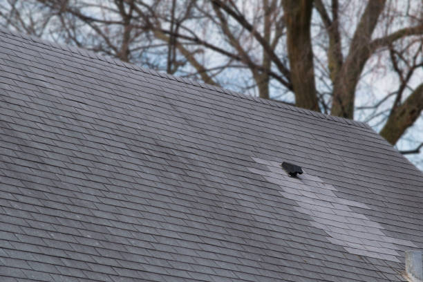 istock Damaged and old roofing shingles on a house 937559364