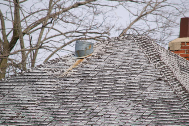 istock Damaged and old roofing shingles on a house 937559398