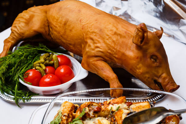 roasted pig on a bed of lettuce. buffet table