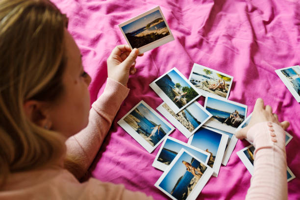 istock Browsing vacation photographs at home 937567762