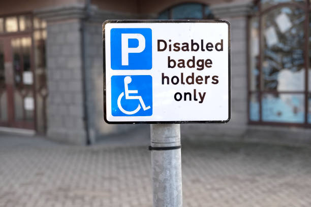 istock Disabled badge holders only sign parking space in car park at shops 937567784