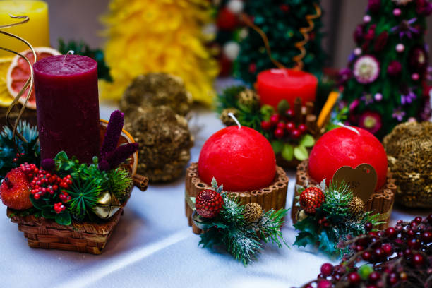 istock Candle decorated with cinnamon sticks and red apples, christmas decoration 937567920