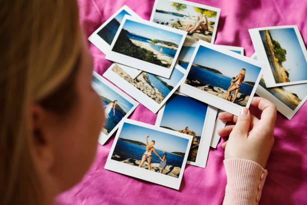 istock Browsing vacation photographs at home 937568224
