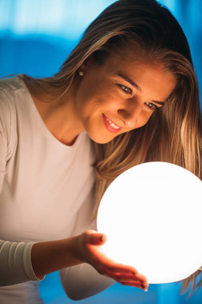 istock smiling beautiful woman looking a crystal ball 937568716