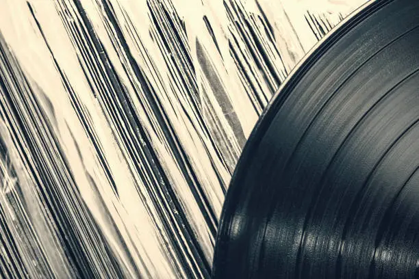Toned image of a vintage collection of 33 RPM LP record albums.