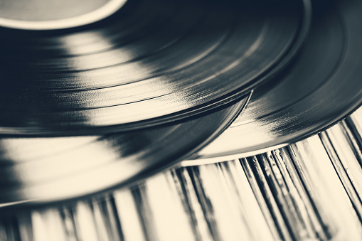 Toned image of a vintage collection of 33 RPM LP record albums.