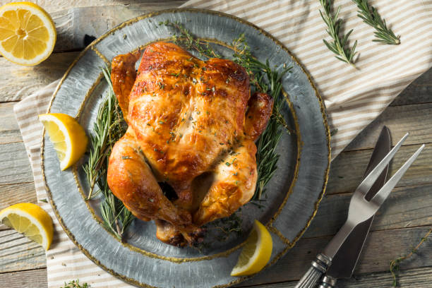 Homemade Rotisserie Chicken with Herbs Homemade Rotisserie Chicken with Herbs and Lemons chicken stock pictures, royalty-free photos & images
