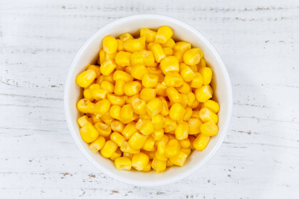 istock Corn grains grain from above bowl wooden board 937574570