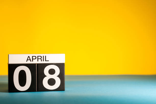 istock April 8th. Day 8 of april month, calendar on table with yellow background. Spring time, empty space for text 937577090