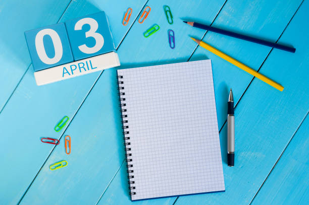 istock April 3rd. Image of april 3 wooden color calendar on blue background.  Spring day, empty space for text 937577322