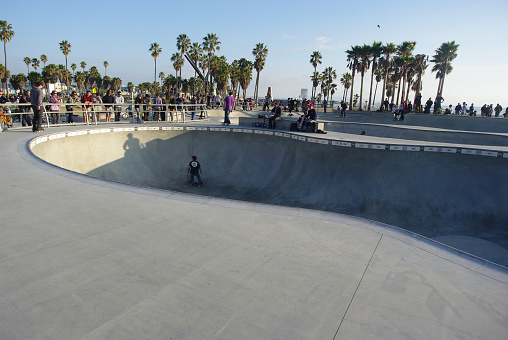 Venice, California - January 10, 2011: Unidentified male attempting to jump over railing while skateboarding at Venice Skate Park in Venice Beach California.