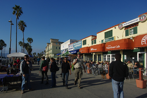 Los Angeles, California, USA - January 1, 2011: public beach and rest on Venice Beach, Los Angeles, California, USA. People on vacation. Picturesque coast of the Pacific Ocean and the center of youth culture and recreation. Venice Beach in Los Angeles