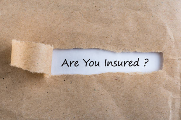 istock Torn paper envelope with word are you insured. Insurance concept 937589970