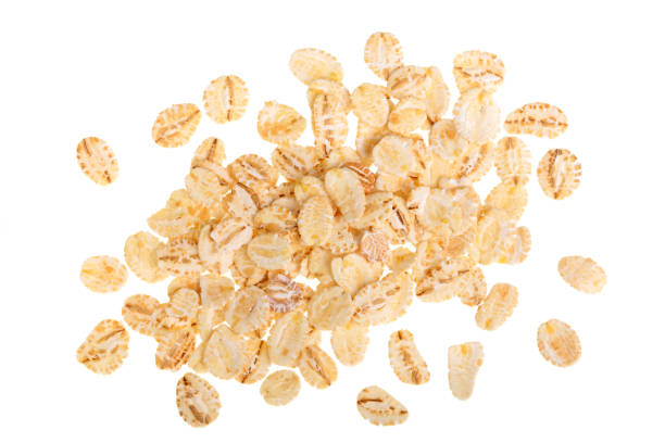 istock oat flakes isolated on white background. Top view 937590044