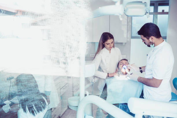 istock Ultraviolet Light Laser Procedure at the Dentist Office 937594696