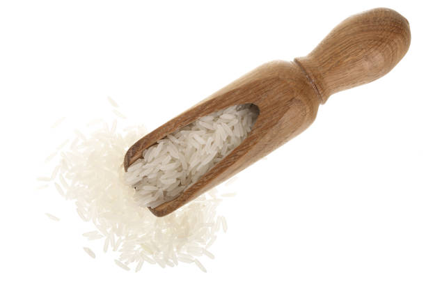 istock rice grains in wooden scoop isolated on white background. Top view. Flat lay 937596992