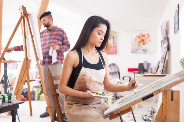 istock Female fine artist drawing in studio 937597990