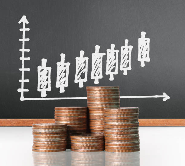 istock Coins graph stock market 937598580