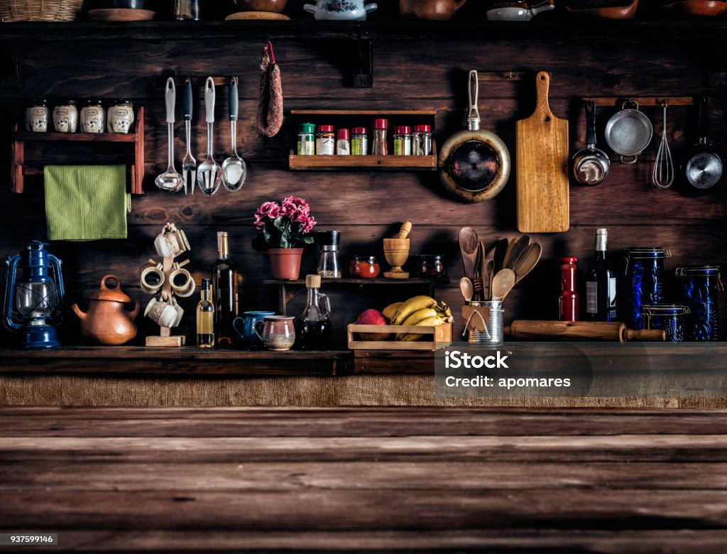 Actual rustic kitchen with utensils for cooking. Table at the foreground with copy space Kitchen Stock Photo