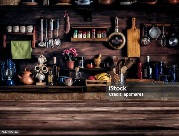 Actual Rustic Kitchen With Utensils For Cooking Table At The Foreground With Copy Space Stock Photo - Download Image Now