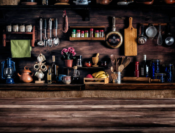 actual rustic kitchen with utensils for cooking. table at the foreground with copy space - kitchen utensil ingredient cooking nobody imagens e fotografias de stock