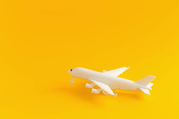 istock Plastic toy airplane on a yellow Background 937601772