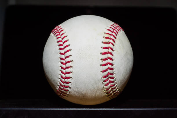 View of baseball with black background A view of a baseball with a black background major league baseball stock pictures, royalty-free photos & images