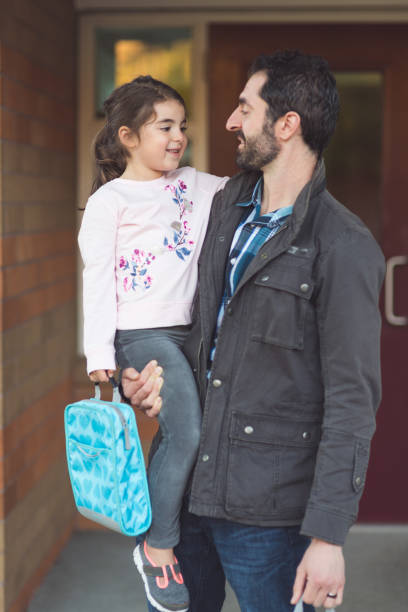 istock Dad drops little girl off at school 937602604