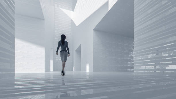 istock Businesswoman walking in empty office hall 937610574