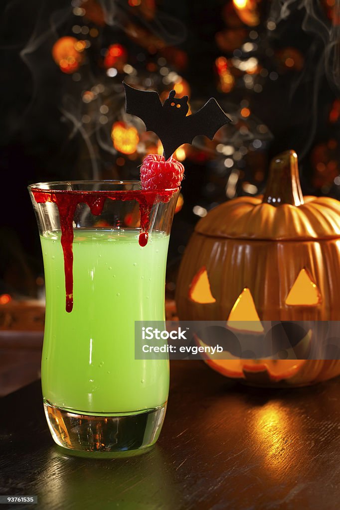 Picture of Halloween drinks, vampires kiss cocktail  Closeup of Vampire's Kiss Cocktail, rum, melon liqueur, soda and touch of tabasco, garnished with fresh raspberry - Halloween drinks series Halloween Stock Photo