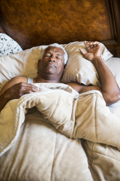 istock Senior Black Man Sleeping and Waking Up 937615942