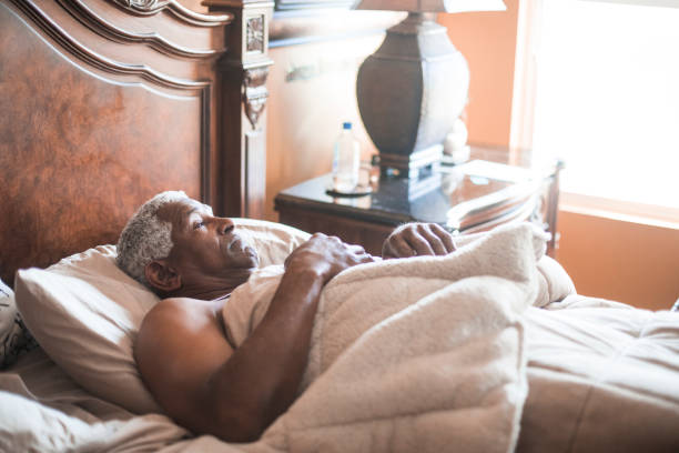 istock Senior Black Man Sleeping and Waking Up 937617960