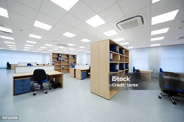 A View Of The Inside Of An Office With Desks And Shelves Stock Photo - Download Image Now