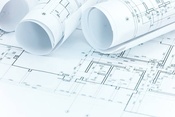 istock set of construction plans and blueprint rolls on architect workplace desk 937653746