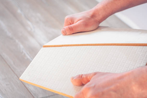 istock Worker breaks the cut tile on a curved line by hand 937685624