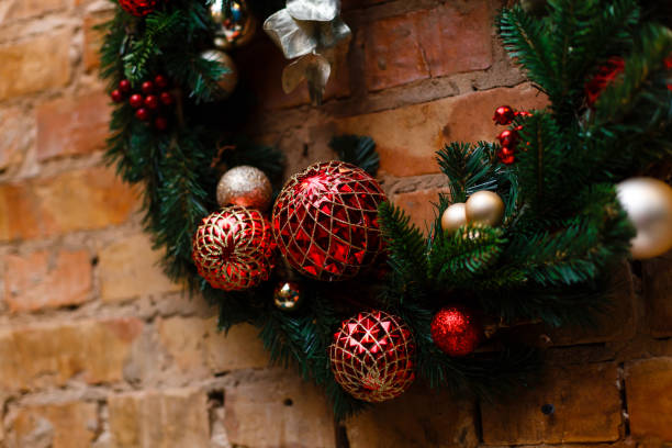 istock Home made holiday wreath hanging on stone wall. 937689642