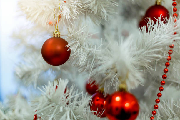 istock Red baubles hanging on silver artificial christmas tree, good as background 937693870