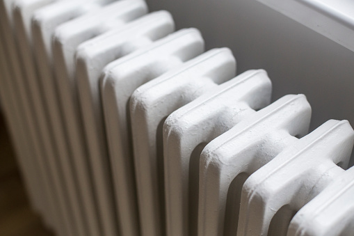 Old radiator in an apartment (winter heating concept).