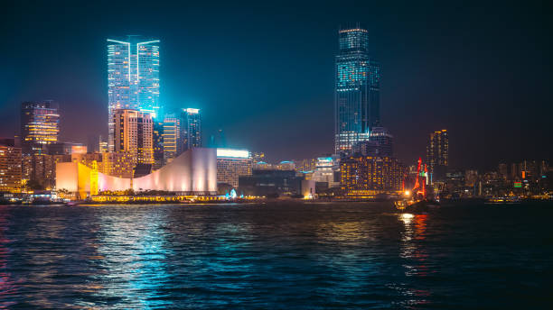 istock Hong Kong Victoria Harbor night view with junk boat on foreground 937695016