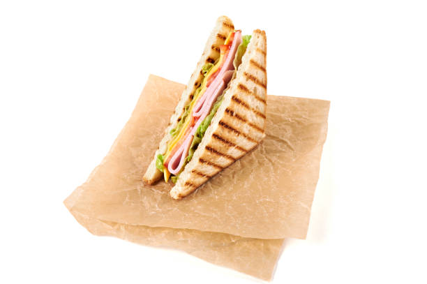 istock Sandwich with ham, cheese, tomatoes, lettuce, and toasted bread. Above view isolated on white background. 937703332