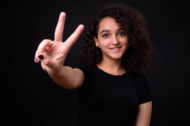 Portrait Of Beautiful Teenager Girl Portrait Of Beautiful Teenager Girl Against Black Background iranian ethnicity stock pictures, royalty-free photos & images